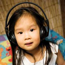 Girl with Headphones in City Library